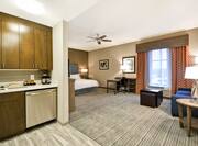Studio Suite With Kitchen, King Bed, Work Desk, Window With Long Drapes, and Seating Area