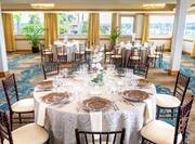 Round Tables Covered in White Linens in Ballroom