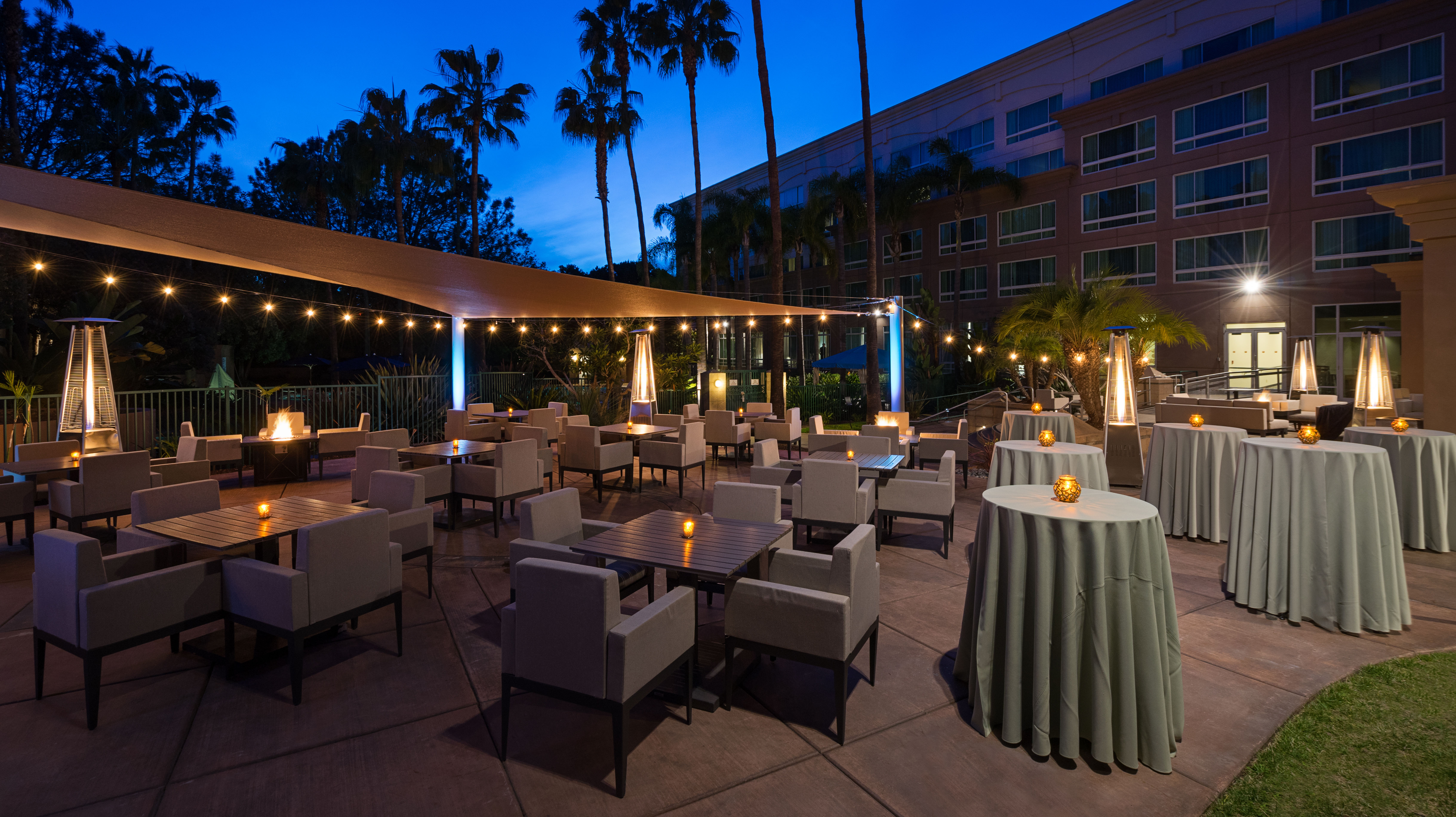 Outdoor Patio at Dusk with Lounge Seating and Cocktail Tables