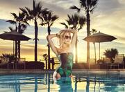 Woman in Outdoor Pool at Sunset