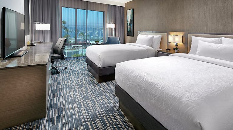 Two Queen Beds with Work Desk, HDTV, and Outside View