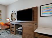 Guestroom With Work Desk And TV