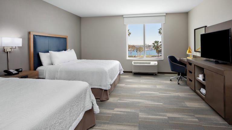 Two Queens Accessible Guest Room with Water View a Desk and TV