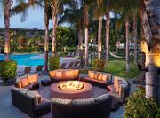 Circular Firepit by Outdoor Pool in Evening