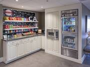 Hotel treat shop with refrigerated drinks and microwave.