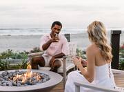 couple having drinks at outdoor fire pit