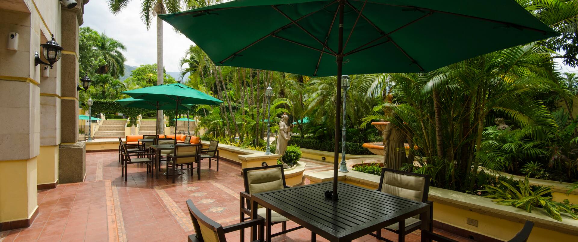 Hotel Outdoor Patio Area with Chairs, Tables and Umbrellas