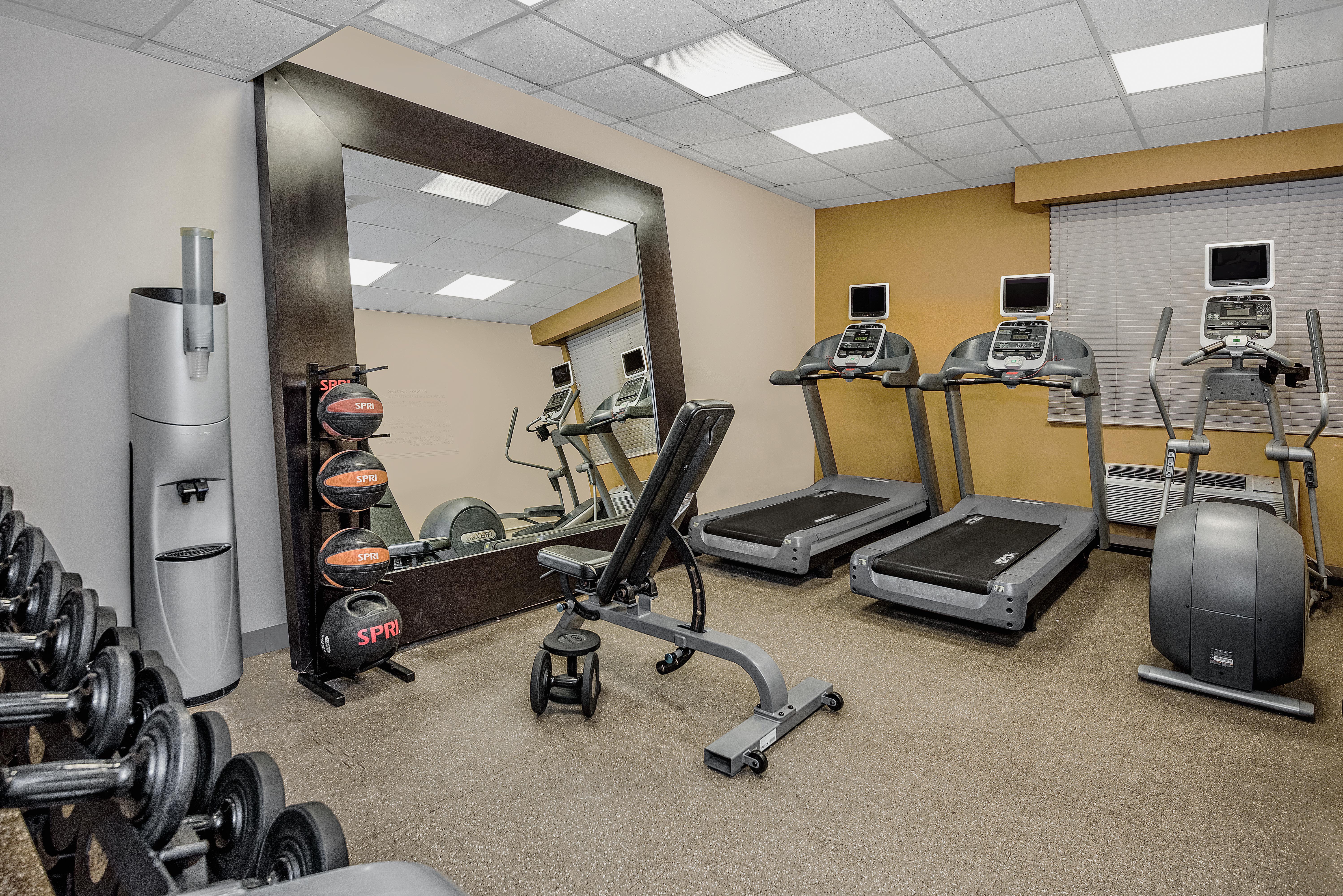 fitness center with treadmills and free weights area