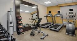 fitness center with treadmills and free weights area