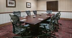 boardroom with chairs and screen