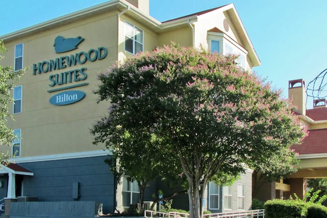 Hotel Exterior with signage and tree