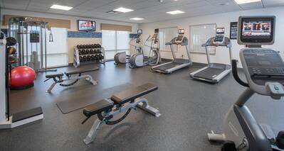 Fitness Center with Treadmills, Cross-Trainers, Dumbbell Rack, Weight Machine, Weight Benches and Cycle Machine