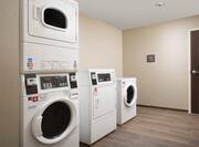 Guest Laundry Room with Washing Machines and Tumble Dryers