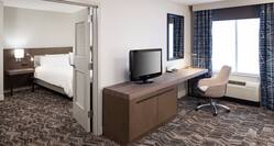 Separate Living Room with TV and Work Desk in King Whirlpool Suite