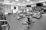 Fitness Center With TVs, Mirrored Wall, Cardio Equipment, Free Weights, Weight Machine, Stability Ball, Weight Balls, and  Bench 