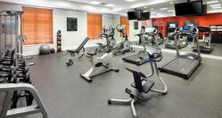 Fitness Center With TVs, Mirrored Wall, Cardio Equipment, Free Weights, Weight Machine, Stability Ball, Weight Balls, and  Bench 