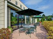 Outdoor Patio with Table and Chairs Covered by Umbrellas