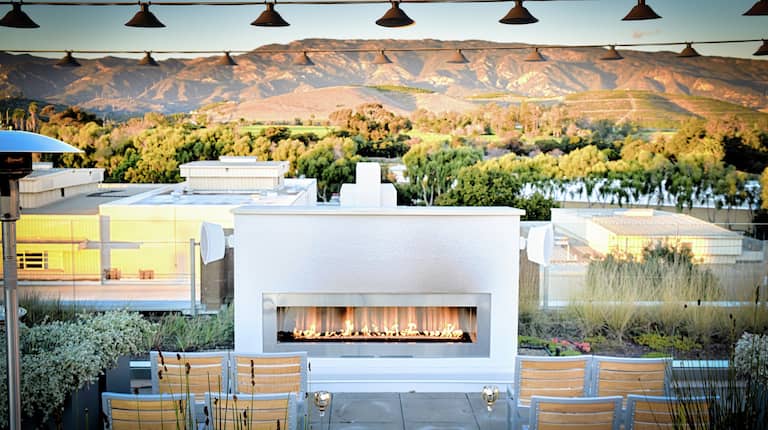 Roof Top Fireplace with Seats and View of Mountains
