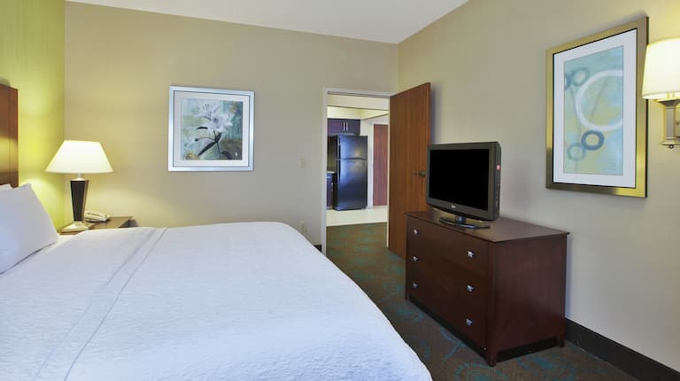 Accessible Single King Guestroom Suite Bedroom with View of Kitchen