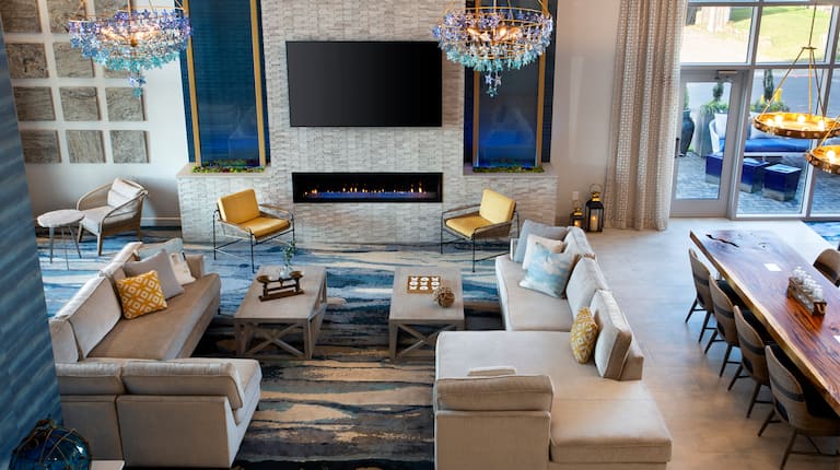 Hotel Lobby, Couches, Community Table and Fireplace