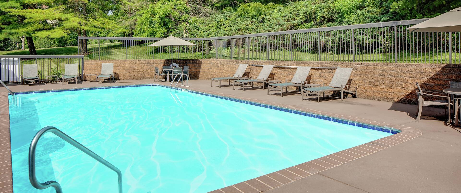 Outdoor Swimming Pool at Daytime with Deck Chairs