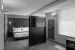 Dormitorio de la suite Junior con cama King y televisor montado en la pared