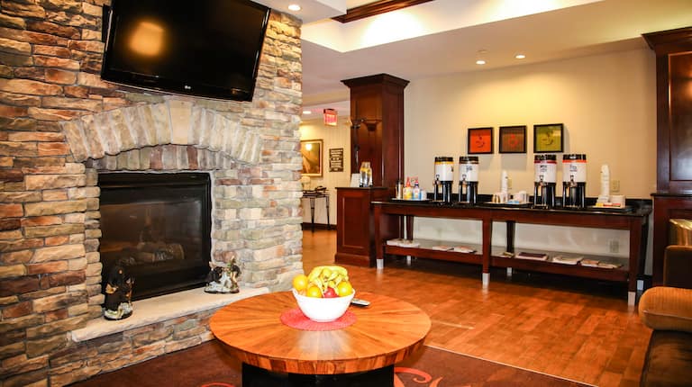 TV and Fireplace in Lobby Lounge With View of Beverage Station in Background