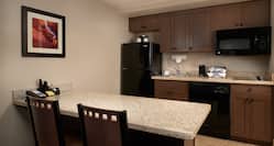 Guestroom Kitchen Area with Refridgerator, Microwave and Cooker