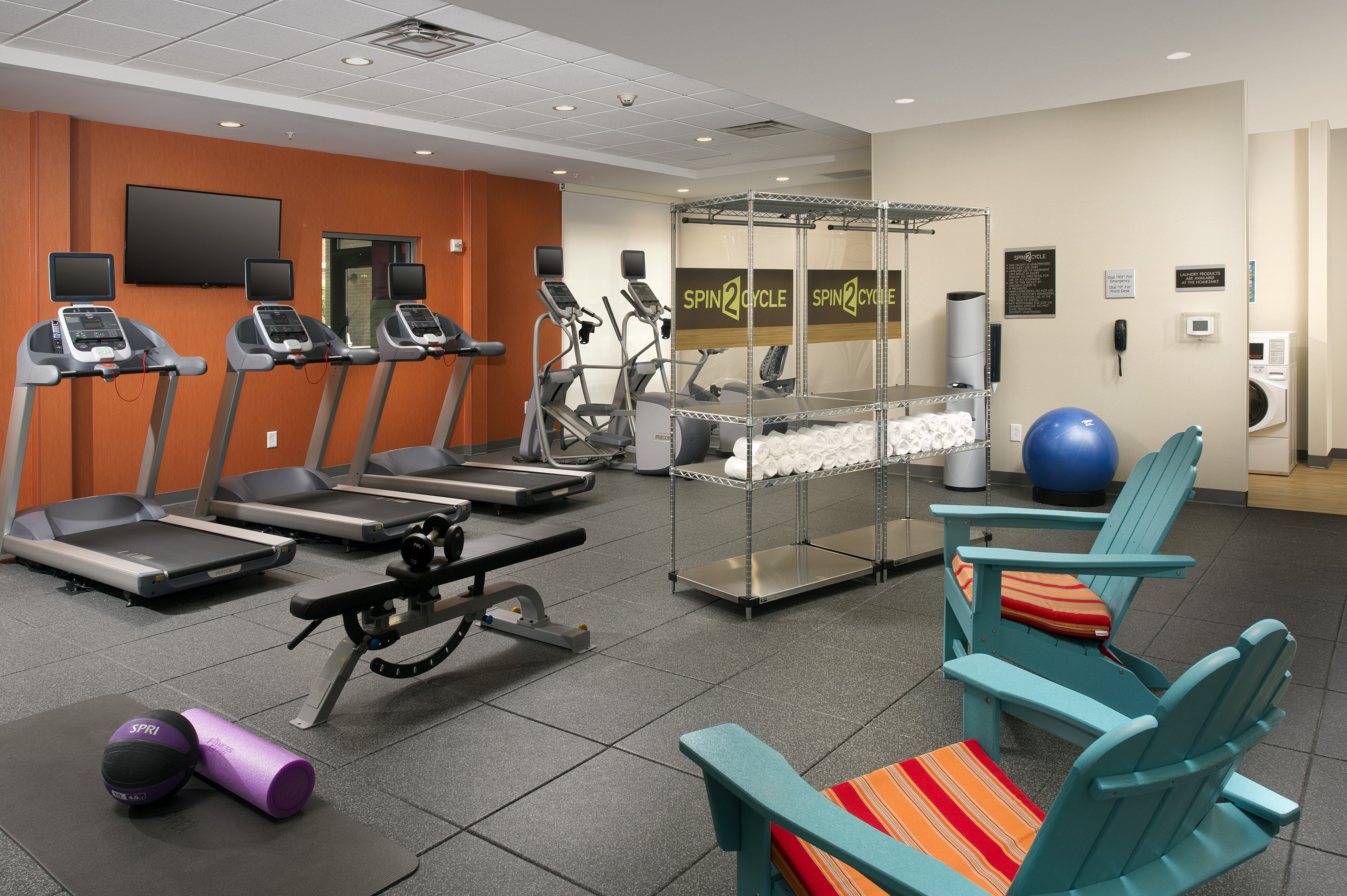 Fitness Center with Treadmills, Weight Bench, Cross-Trainer and Wooden Armchairs