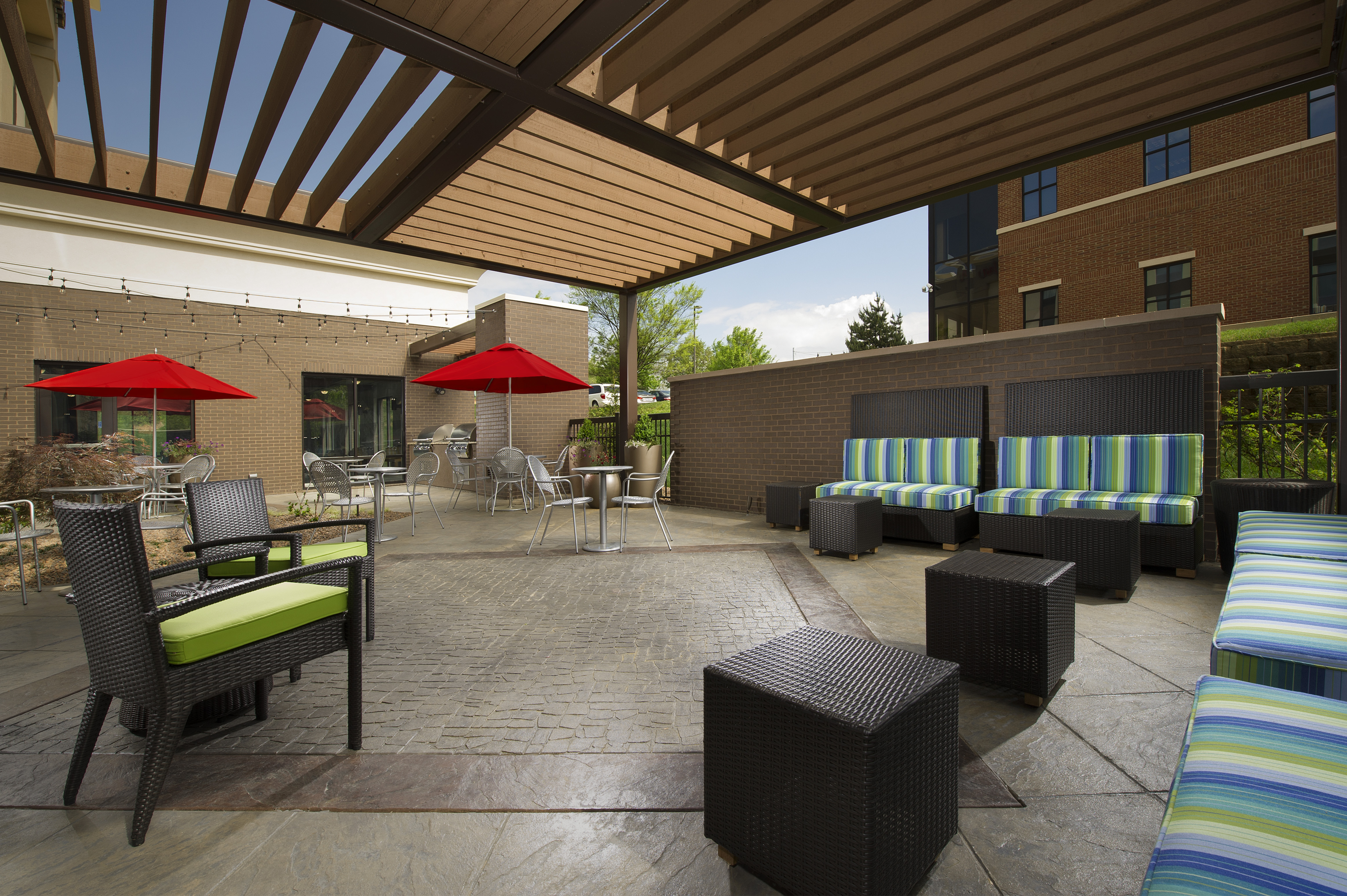 Outdoor Patio Seating Area with Armchairs, Tables and Umbrellas