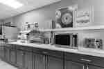 Breakfast serving area with appliances, food stations, and blue cabinetry.