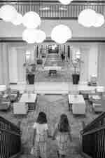 Two Girls Holding Hands and Walking Towards Lobby Area