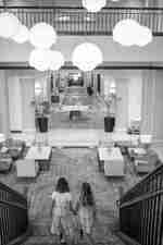 Girls, Holding Hands, Going Down the Stairs in Lobby Area