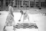Girls Playing Checkers in Outdoor Pool Area