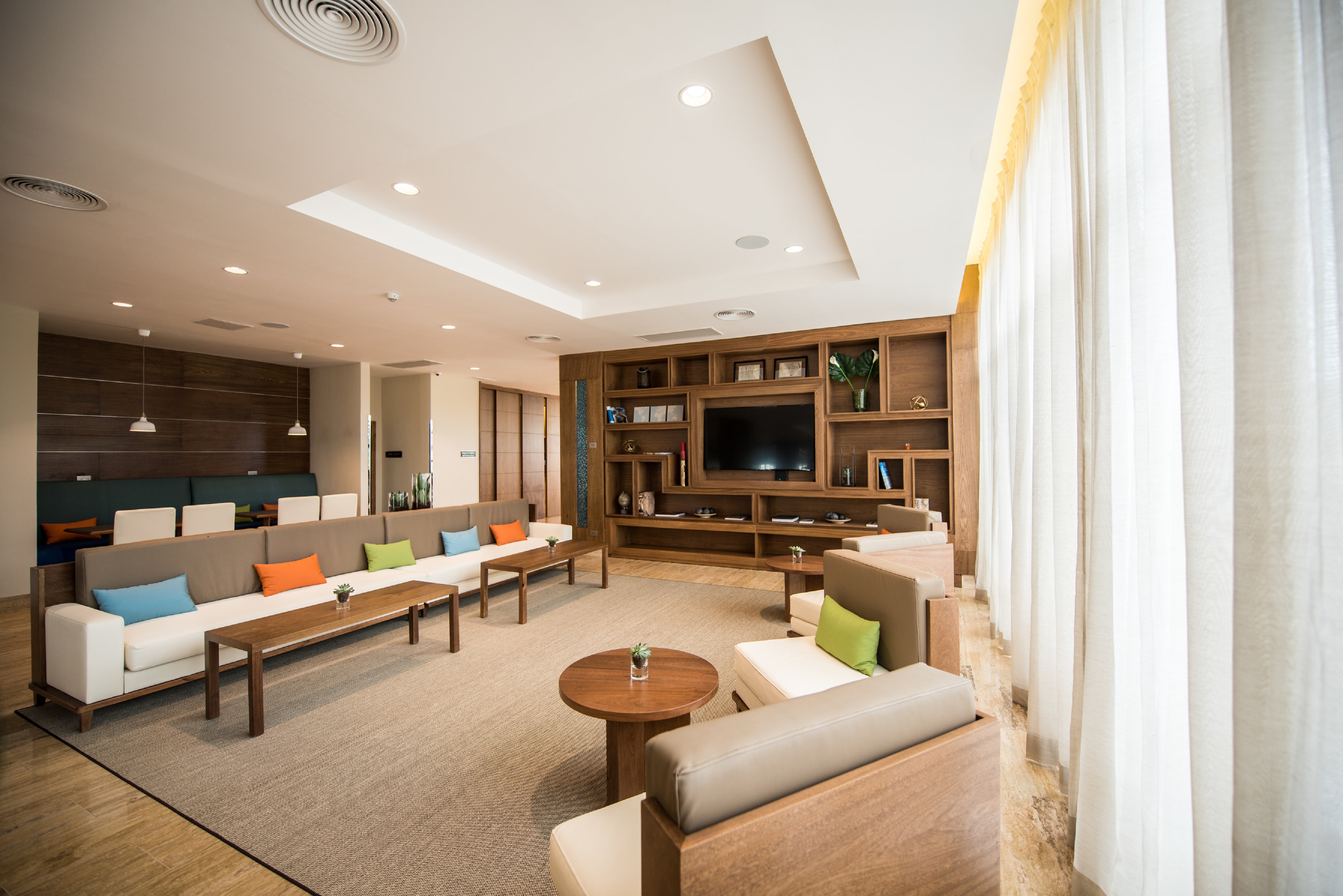 Lobby Seating Area with Soft Seats, Coffee Tables and Wall Mounted HDTV