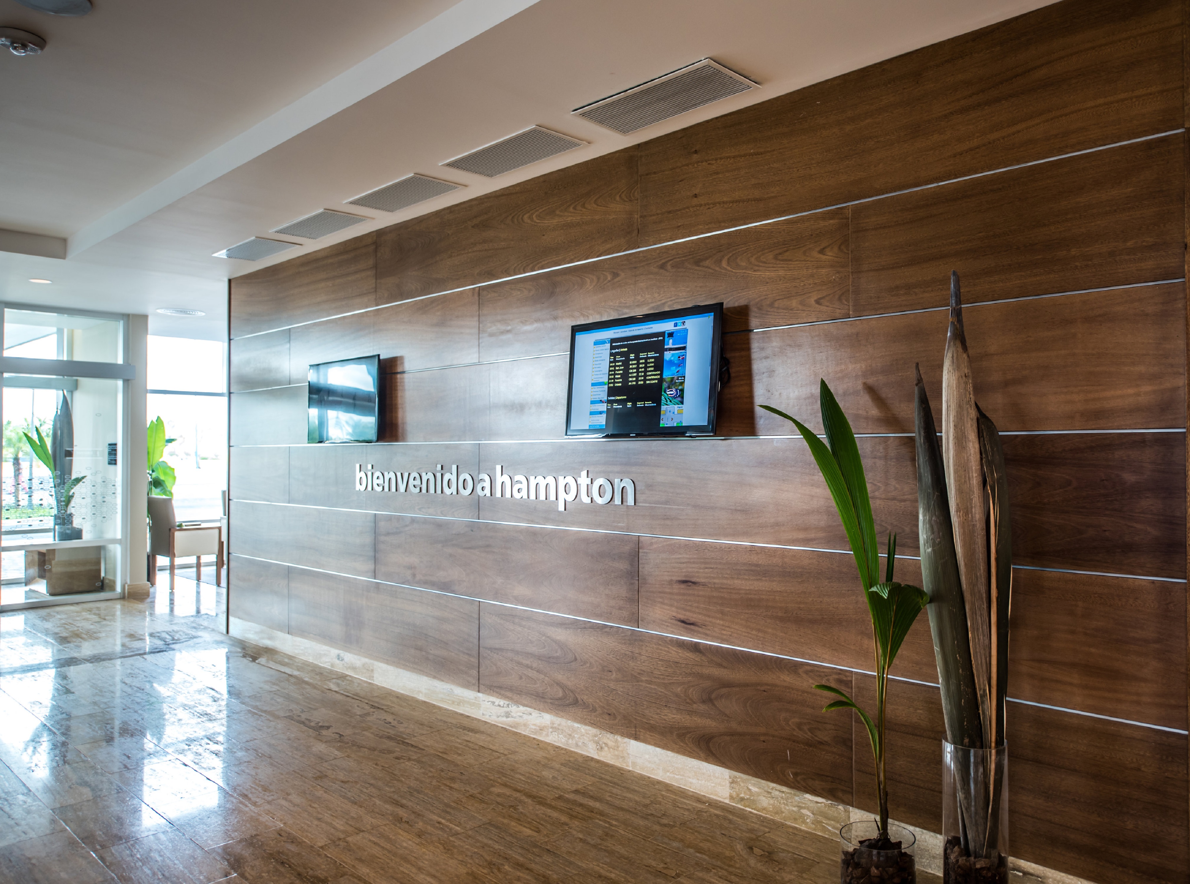 Hotel Lobby Entrance Area with Two Wall Mounted HDTVs