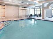 Indoor Swimming Pool Area with Table and Chairs