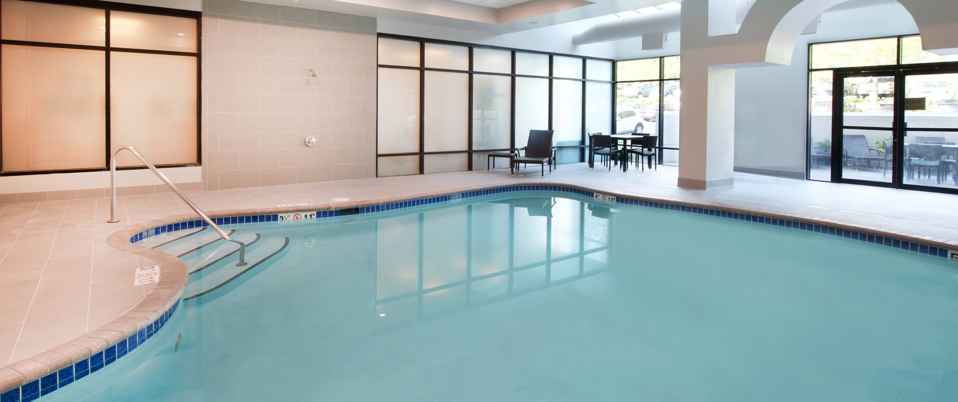 Indoor Swimming Pool Area with Table and Chairs