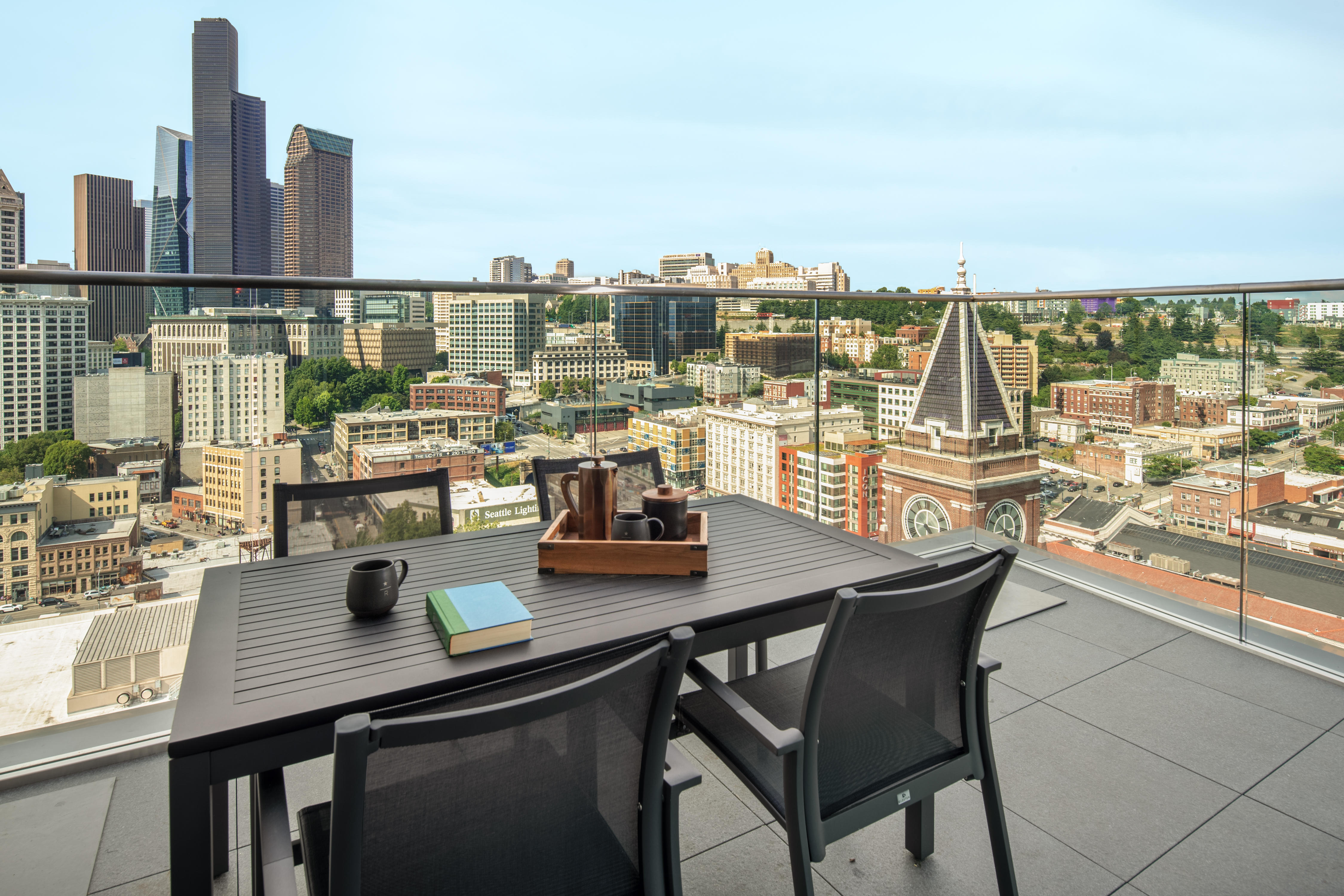 Penthouse View of City from Balcony with table and chairs
