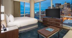 Guestroom with King Bed, Television, Sofa and City View