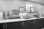 breakfast bar area with food and dispensers