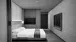 Guest room with one bed, a wall-mounted TV across from the end of the bed, a work desk, a wet bar, and the door in the background.