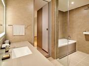 bathroom with tub and shower