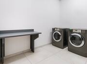 Laundry room with machines and table
