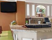 Bar Lounge Area with Bar Counter, Bar Stools and Wall Mounted HDTV