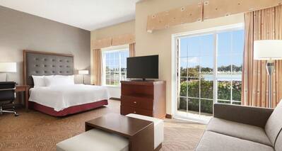 Studio Suite King Bed and Lounge Area Seating with View of Waterway