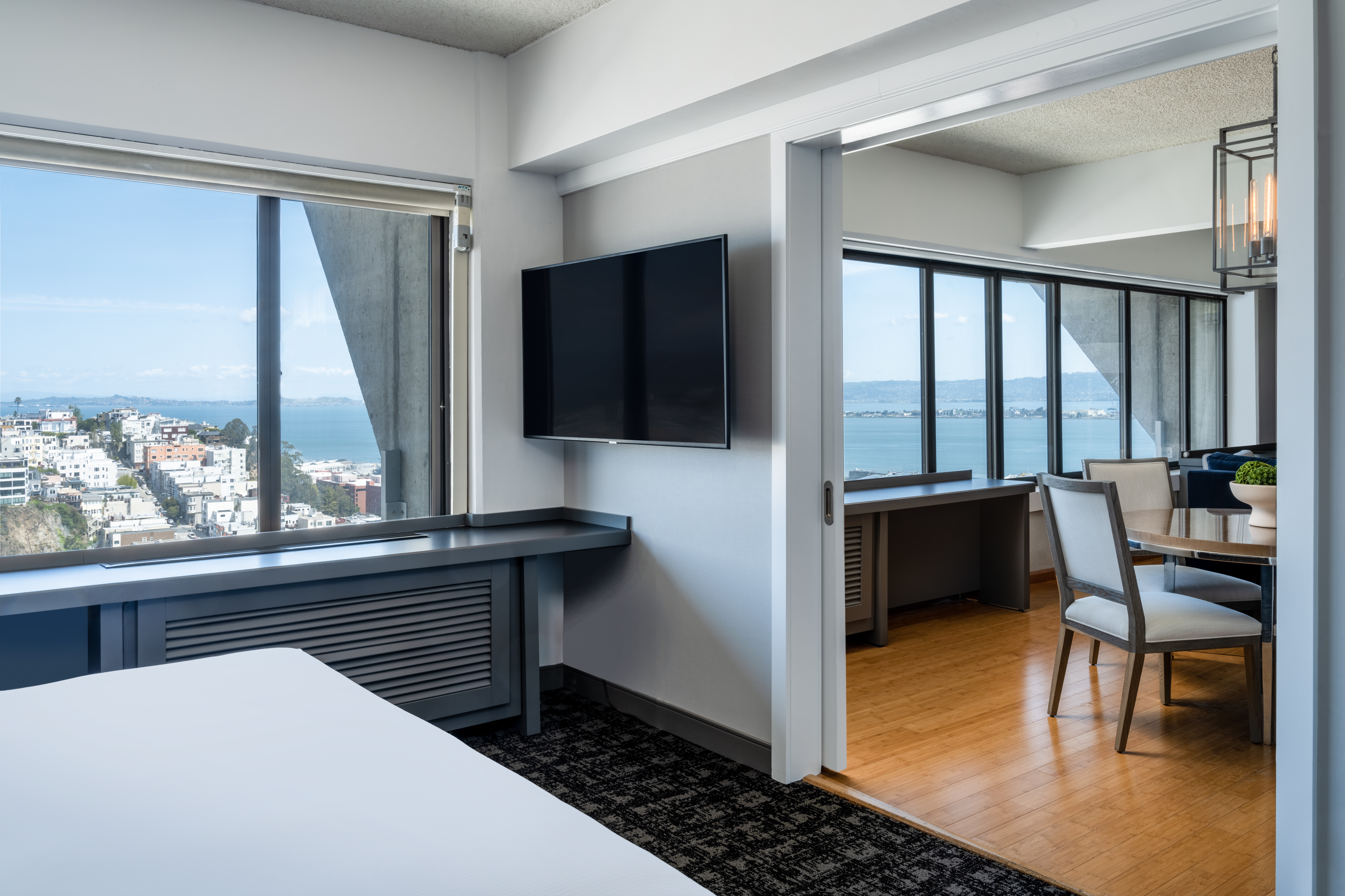 King Ambassador Suite with Bed, TV, Lounge, and Outside Bay Views