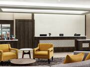 Spacious hotel lobby featuring comfortable seating, welcoming front desk, and convenient snack shop.