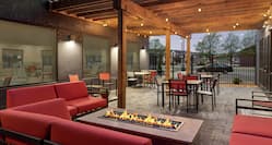 Spacious outdoor patio featuring comfortable sofa-style seating, firepit, and string lights.