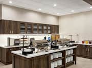 Bright breakfast serving area featuring complimentary daily buffet overflowing with delicious food and beverage.